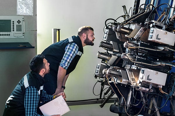 Engineers troubleshooting an industrial machine.